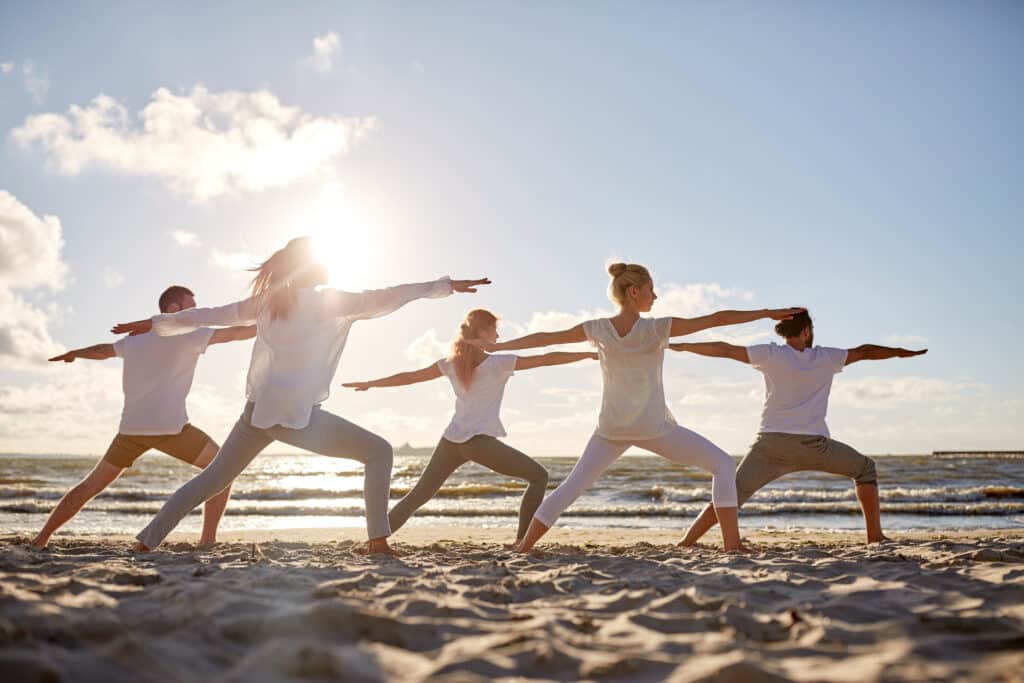 Yoga session running on beach.