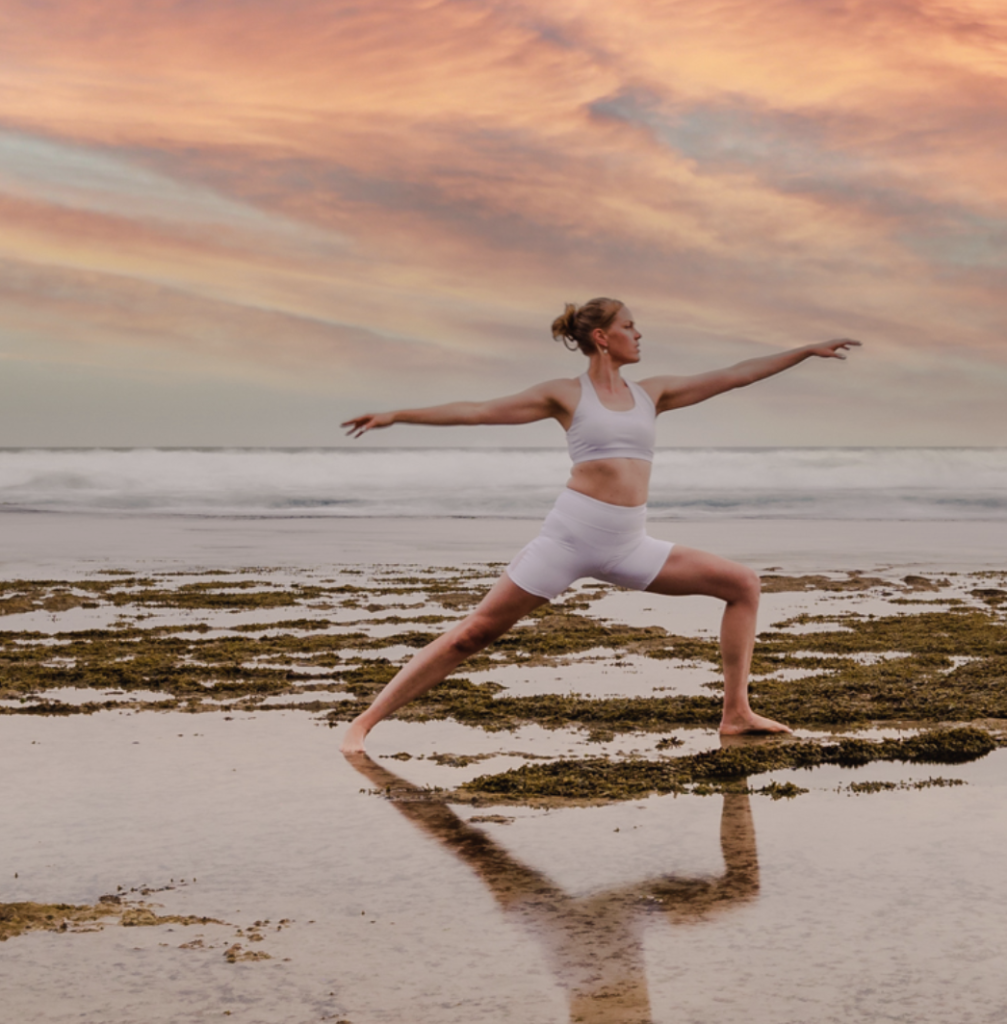 Woman doing weight loss yoga poses on beach.