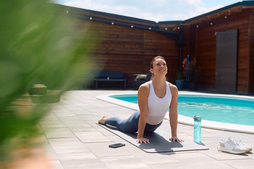 Woman doing cobra pose in yoga.