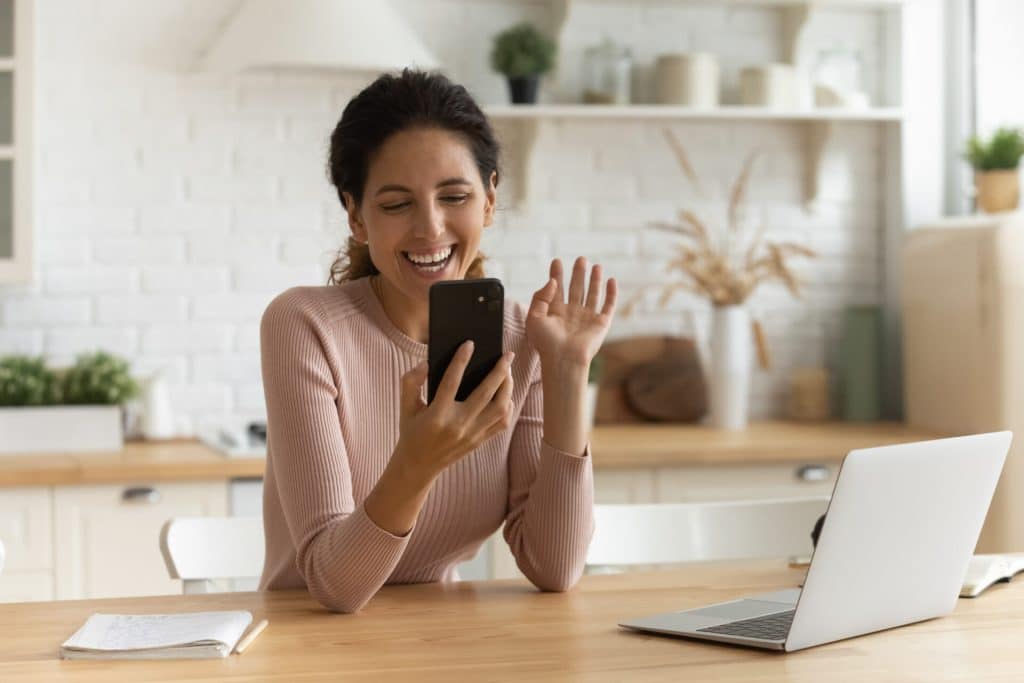 Woman on call with her wellness coach with her laptop in front of her.